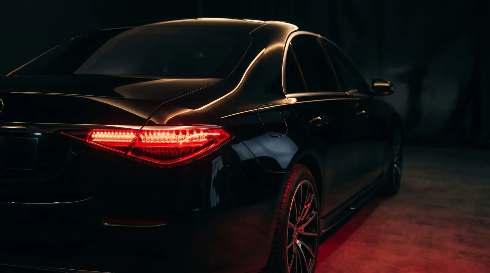 Premium car rental in Gujrat — a luxury car lit at night